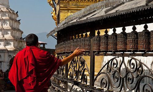Monk Turning Prayer Wheels At Swayambhunath Stupa